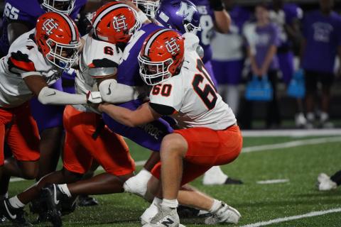 A host of Dogs defenders bring down the Monroe Area running back in the 25-13 loss Sept. 19. (Photo by Ric Williams)