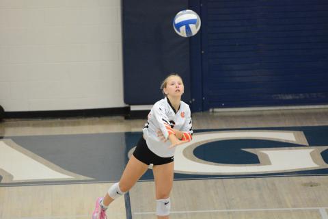 Sophomore defensive specialist Addison Coles serving the ball into play in the 2-0 win over East Jackson Sept. 25. (Photo by Benjamin London)