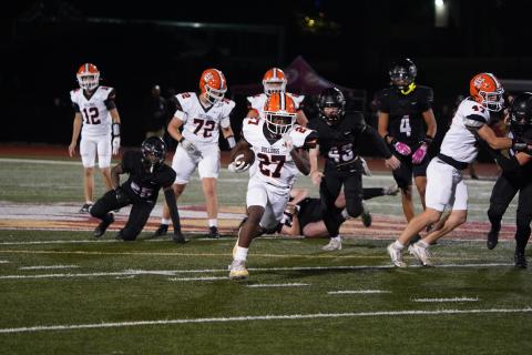 Freshman running back Ian Sheppard (27) breaks free for a late 44 yard touchdown run in the 54-10 loss to the No. 1 ranked Lions of Hebron Christian Oct. 3. (Photo by Ric Williams)