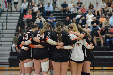 The Volley Dogs huddle up to pray before a match earlier in the season against A.R. Johnson of Augusta Oct. 14. (Photo by Benjamin London)