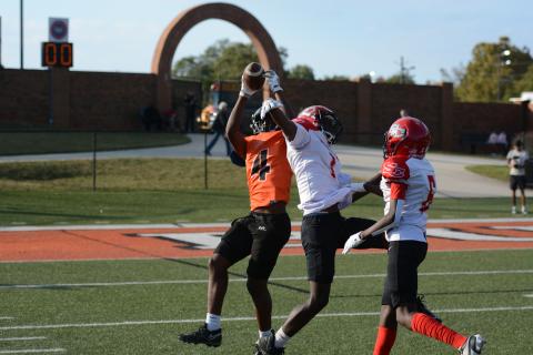 HCMS wide receiver Caleb Wilkins leaps over the Rebels defender to snag the ball and dash into the endzone for a 50 yard receiving touchdown in the 12-6 win over Stephens County Oct. 9. (Photo by Benjamin London)