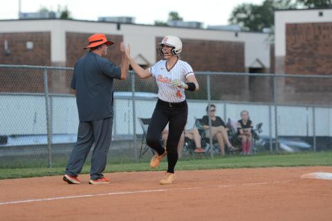 Senior infielder Madi Bennett rounds third and high fives Lady Dogs head coach Gerald Gates after hitting a solo home run en route to a 7-4 win over the Lady Tigers of Commerce Oct. 8. (Photo by Benjamin London)