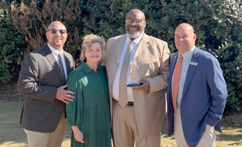 Pictured (L-R) are Hart College and Career Academy CEO Steve Burton, Superintendent Jennifer Carter, Coach William DeVane and Associate Superintendent Brooks Mewborn after Coach DeVane received the 2025 Pioneer in Education award. 