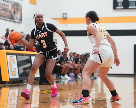 Junior guard Kiasia Montgomery looks to pass to an open teammate in the paint during the dominant 70-28 win over the Lady Tigers of Crescent Dec. 12. (Photo by Ric Williams)