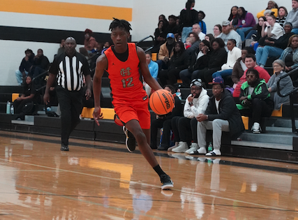 Junior forward Zayden Leverett brings the ball up the court. (Photo by Ric Williams)