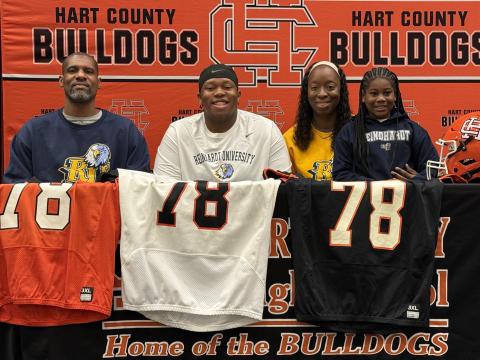 Pictured middle is Nicholas Carter with his family, as he signed with Reinhardt for football. Photo by Benjamin London.