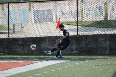 Midfielder Johan Santos Perez sends the ball into play earlier in the season, as he scored goal and collected an assist in the 3-0 win over East Jackson March 13. Photo by Benjamin London.