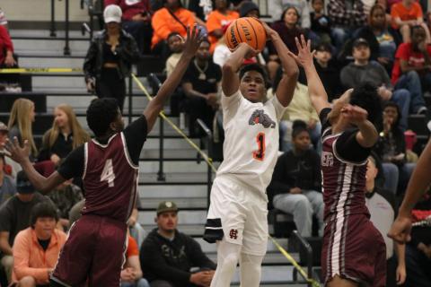 Junior guard Kurston Curry drains a three in the face of multiple defenders, as he tied his career high scoring 32 points in the 89-72 win over the Panthers of Carver (Atlanta) Feb. 28. Photo by Grayson Williams.