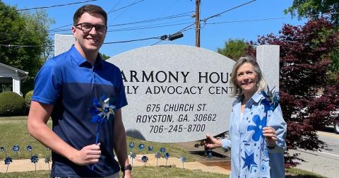 Harmony House's Darrin Haley, director of clinical services, (left) and Laurie Whitworth, executive director (right) wore blue and held pinwheels outside the organization's Royston office in recognition of Child Abuse Awareness Month earlier in April. The organization, which serves the counties that make up the Northern Judicial Circuit, including Hart County, serves victims of sexual assault and abuse across all ages. Photo courtesy of Harmony House Child Advocacy and Sexual Assault Center.
