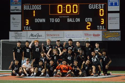 Photo by Benjamin London The Hart County High School boys soccer team celebrates after their historic 1-0 win over the Lions of Hebron Christian March 31, as they set school history capturing their 13th win of the season. Photo by Benjamin London. 