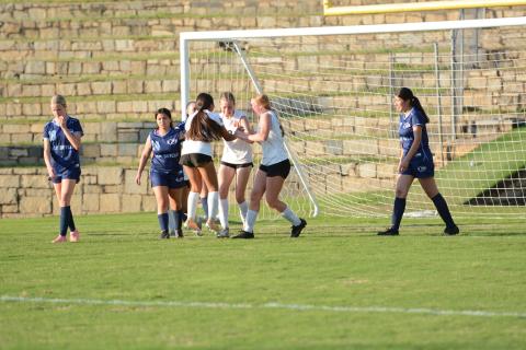 Isla Bell (middle) celebrates with her teammates after scoring a late goal in the 5-2 win over Elbert County April 14.  (Photo by Benjamin London)