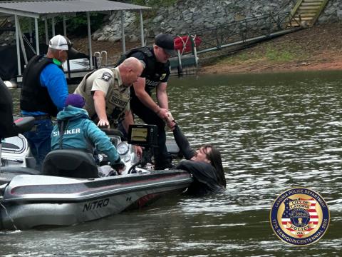 Hart County Sheriff's Office Cpt. Matt Gulley helps the Lavonia Police Department retrieve a suspect out of the waters of Lake Hartwell in Gumlog following a stolen car chase May 24.  Photo courtesy of the Lavonia Police Department. 