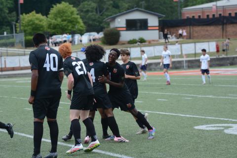 Cayson Craft celebrates with his teammates after scoring the lone goal in the 1-0 win over the Eagles of East Jackson in the Sweet Sixteen May 1. Photo by Benjamin London.