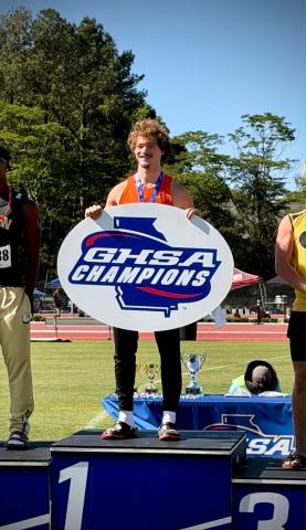 Senior pole vaulter Luke Samples on the podium after capturing his third state title in the event May 14. Photo submitted by Sissie Samples.