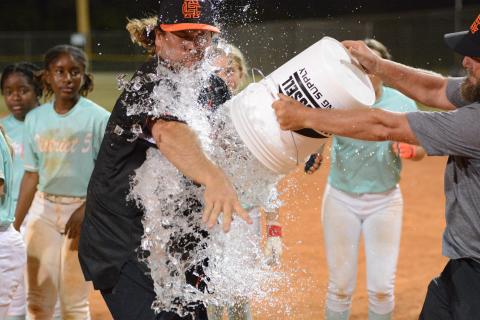 Hart County Little League’s president and the Senior League softball team’s manager Mason Bowers receives a ice bath after capturing their fourth straight state title to advance to the Southeast Regional July 24-27. Photo by Benjamin London.