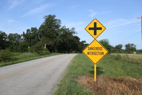 Dangerous intersection signs are posted on both sides of the road before the intersection of Liberty Hill and Liberty Hill Church roads, which is now set to become a four-way stop.  Photo by Rose Scoggins. 