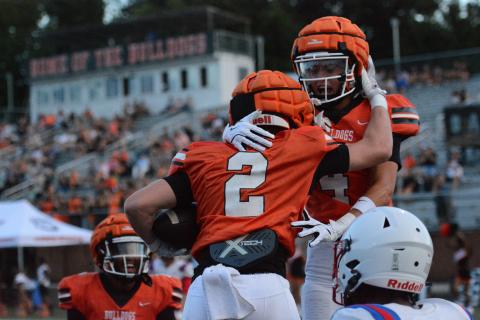 Senior wide receiver Knox Pierce (2) celebrates with teammates Crew Franklin (right) and Kurt Curry (left) after scoring the opening touchdown of the game in the 49-0 win Aug. 7.  Photo by Benjamin London. 