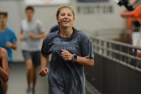 Freshman runner Posie Phillips jogs around the indoor track at the Hart County High School gym during a practice July 29. Photo by Benjamin London.