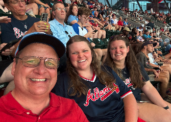 After three games of watching the Braves lose and two more with rain delays, we've decided our Scoggins family trio is cursed. We were able to get in this selfie before the rain poured last Thursday. Pictured are (L-R) Shane, Rose and Marlie Scoggins. Photo courtesy of Rose Scoggins.