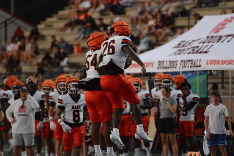 Junior running back Zeebo Harper (26) celebrates his touchdown run with junior lineman Kalik Pickens (54) in the 34-26 win over Oconee County Aug. 13. Photo by Benjamin London.