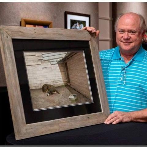 Local artist Michael England poses with one of his watercolor works, "Blue Tin" at the Hartwell Arts Center. Photo courtesy of Michael England. 