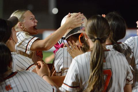 Senior infielder MaryBeth White gets mobbed by her teammates as she walked it off with an RBI single to run-rule the Lady Devils of Elbert County in six innings, 8-0, Sept. 17. Photo by Benjamin London.