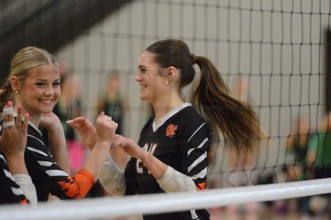 Junior outside hitter Coley Phillips (right) celebrates with junior middle Blair Allen after Phillips collected a kill in the 2-0 win over Stephens County Sept. 15. Photo by Benjamin London.