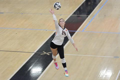 Pictured is junior outside hitter Coley Phillips going up for the kill.  Photo by Benjamin London. 