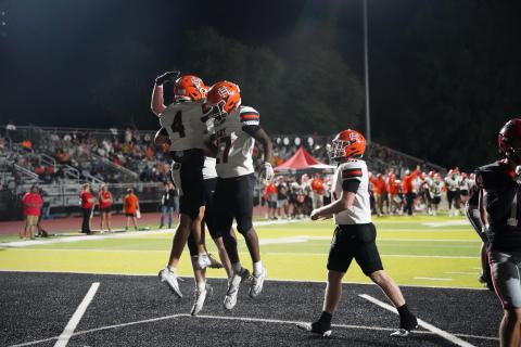 Senior wide receiver Crew Franklin (4) celebrates with his teammates after hauling in his second receiving touchdown of the season in the 35-12 win over the Bulldoggs of Winder-Barrow Sept. 11. Photo by Ric Williams. 