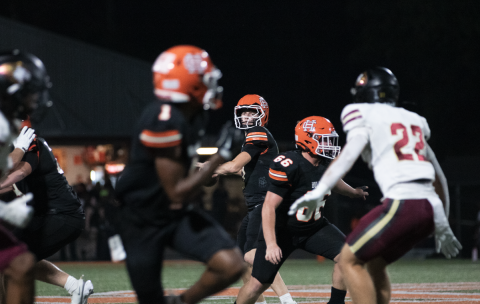 Pictured is sophomore quarterback Tucker Parson rearing back to throw to senior running back Xavier Allen for the opening touchdown for the Dogs.  Photo by Grayson Williams. 