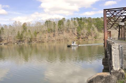Tom Law / On an early spring day, a Lake Hartwell boater makes his way between the spans of Broken Bridges – traveling directly on the state line of Georgia and South Carolina.