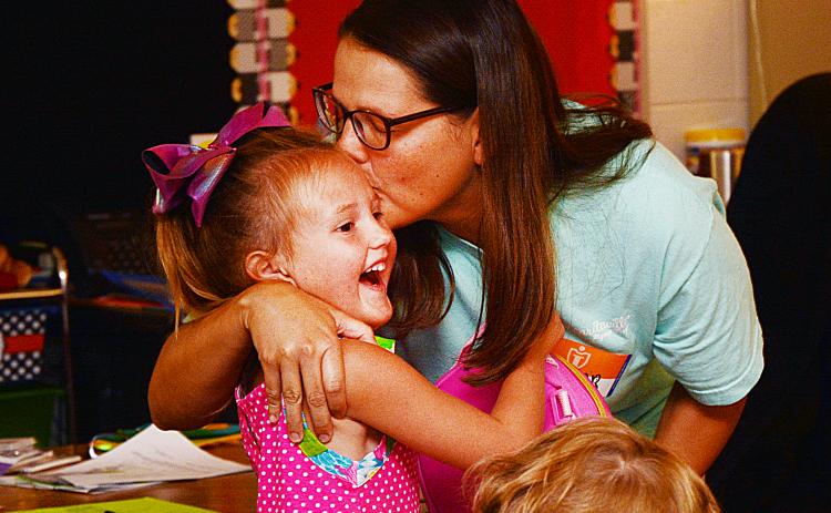 Sunshots by Michael Hall Jantzen Carter, above, kisses her daughter Lailan, 5, before leaving her with her teachers and classmates on the first day of school on Aug. 1 at North Hart Elementary School.