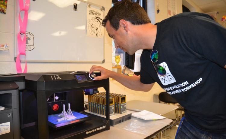 Hart County High School science teacher Justin Lee recently spent some time at a workshop at the University of Florida learning more about human evolution and how to print 3-D replicas of hominid skulls to incorporate into his curriculum. Pictured, Lee readies the 3-D printer at HCHS to give his students the ultimate experience on the subject.