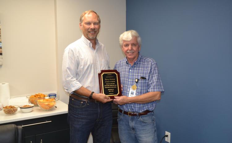 Terry Norton, right, retired this week after 50 years of service to Royston LLC. Norton was presented with a plaque commemorating his five decades of hard work by engineering manager Ben Credle, left.