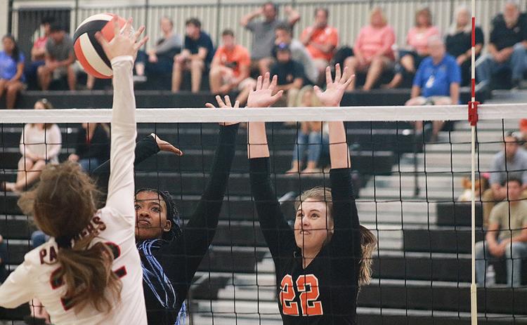 Sunshot by Grayson Williams — Hart County Volleydogs Perrisha Allen and Madison Wolfe go for the block against Jackson County on Sept. 5 at Hart County High School.