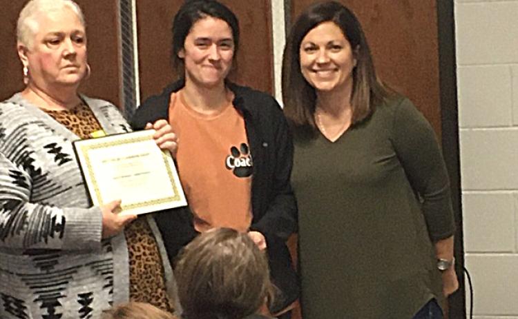 Denise Childs, left, and Nicole Wheless, right, present special education teacher Ashley Mccurley with a certificate for the Joey Childs Classroom Grant. Photo submitted