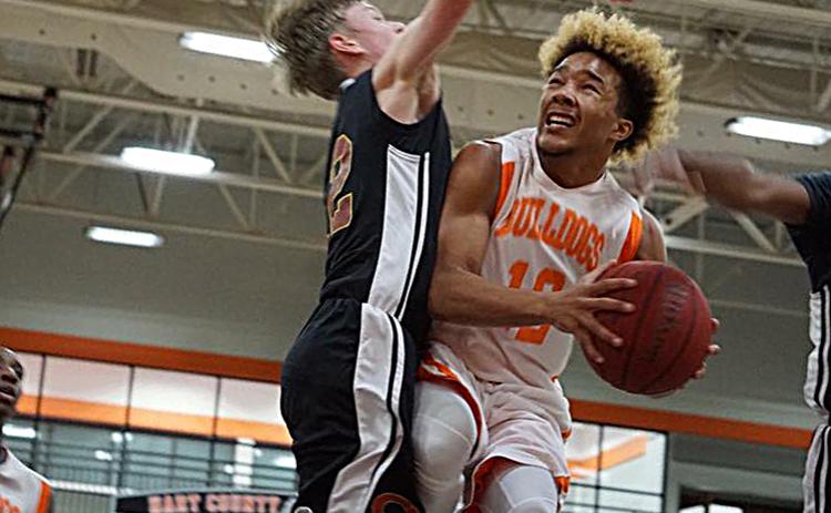 Photo submitted — Hart County sophomore Sean Teasley, right, takes the ball to the hoop in a game last season at the Hart County High School gym. Teasley has been chosen to represent the US team in an international competition.
