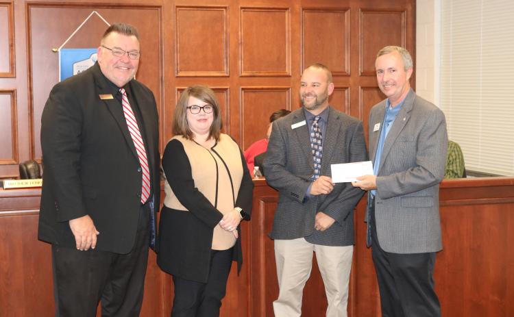 Sunshot by Grayson Williams - Superintendent Jay Floyd, from left, and Hart County Board of Education chairperson Kim Pierce, pose for a photo with Hart College and Career Academy CEO Brooks Mewborn as Mewborn accepts a donation from Georgia Power’s Kevin McCraney to help fund an aerodynamics lab at the academy.