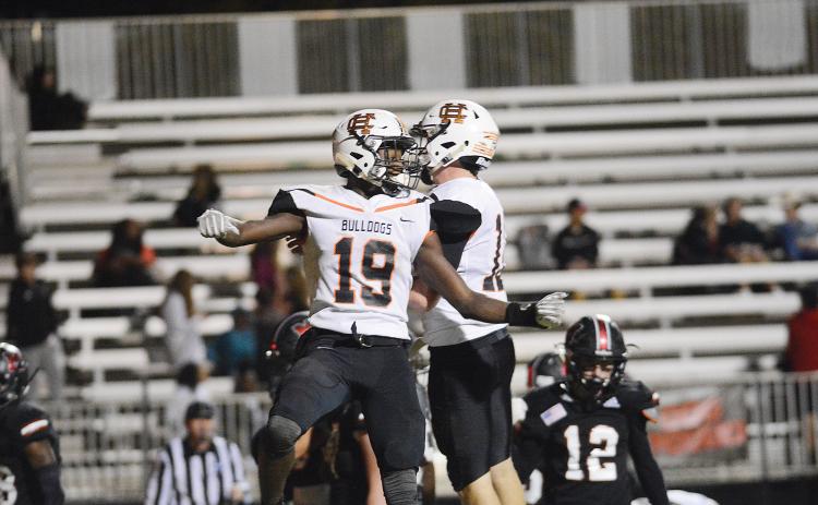 Hart County's Malachi Thomas, who finished with four touchdowns, 290 yards rushing and an interception in the game, celebrates with quarterback Luke Lee in the Bulldogs' win over Morgan County.
