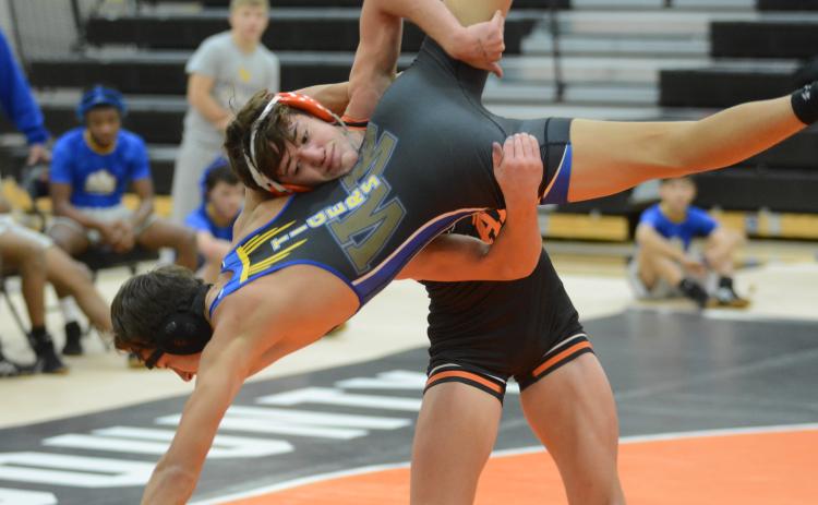 Sunshot by Grayson Williams - Hart County’s Ayers Honiotes takes down a Washington-Wilkes opponent at Hart County High School on Dec. 4.