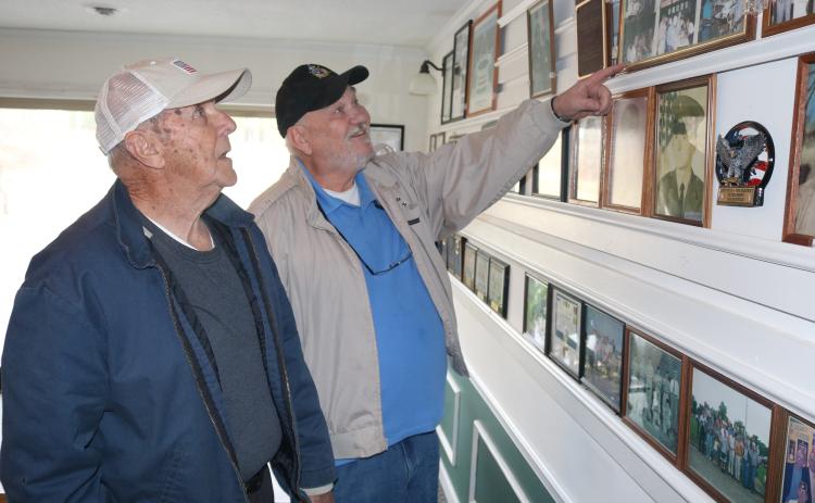 Sunshot by Grayson Williams - American Legion Post 109 members Charles Howard, left, and Sidney Reed, right, look at pictures on the wall at the Post’s clubhouse in Hartwell.