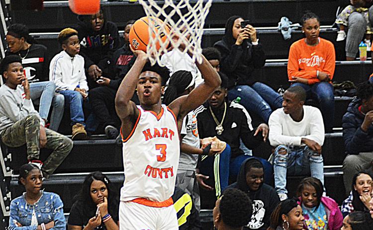 Sunshot by Michael Hall - Hart County’s Tahj Johnson puts up a shot from the corner in the first half on Jan. 10 at Hart County High School. Johnson dropped a team high 23 points in the game, a majority of which came in the first half.