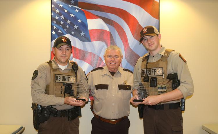 Sunshot by Grayson Williams - Hart County deputies Steve Williams, left, and Matt Sparrow, right, pose for a photo with special plaques presented to them by Hart County Sheriff Mike Cleveland, center, for saving a man’s life.