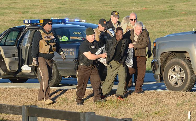 Sunshot by Michael Hall - Hart County Sheriff Mike Cleveland, right, and deputies escort Larrendrick Rashad Tabor, center, from a squad car to an ambulance after his arrest Tuesday, Jan. 28, for his alleged involvement in a Monday night murder in Hart County.