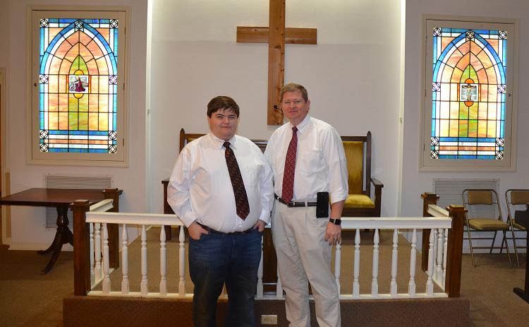 Sunshot by Drew Dotson - Matthew Strickland, left, and Arnold Strickland, right, pose for a photo in the chapel at Strickland Funeral Home in Hartwell. The funeral home is turning 45-years-old this year.