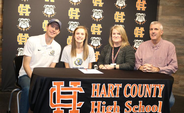 Sunshot by Grayson Williams Jillian Hoell second from left, signed on Jan. 31 to run cross country at Reinhardt University next season. Pictured are Reinhardt coach Jordan Turner, Hoell, her mother Sarah Hoell and father Roy Hoell.