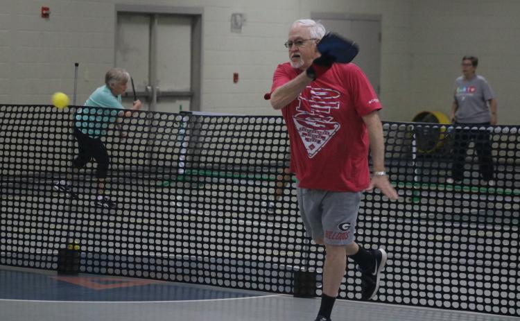 Sunshots by Grayson Williams - Paul Martin, above, volleys during a pickleball game at the Bell Family YMCA in Hartwell on Tuesday.