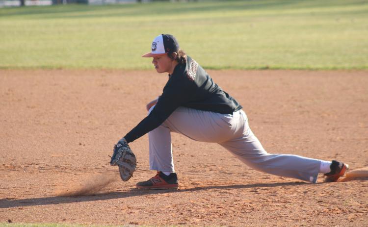 Sunshot by Grayson Williams - Sophomore first baseman Nolan Dean digs a ball out of the dirt last week at Hart County baseball practice.