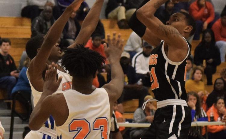 Photo submitted - Hart County’s Shone Webb shoots over Central High School, Macon, players in Macon on Feb. 20.