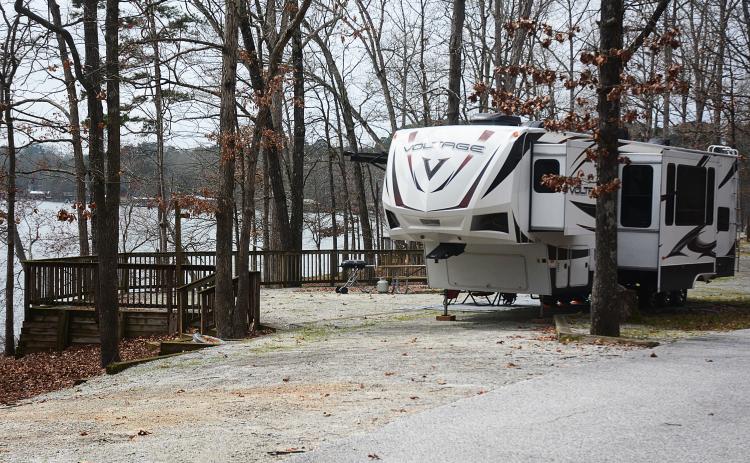 Sunshot by Michael Hall — A fifth-wheel camper is parked at a campsite at what was Hart State Park, and is becoming Hartwell Lakeside. Campground renovations are the first phase of the transformation.